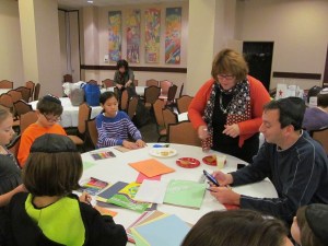 Youth Director Sharon Rappaport and kids make art